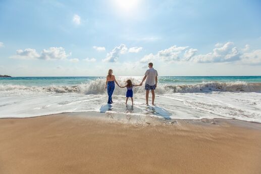 family by the shore at the beach