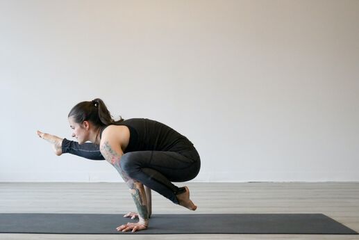 woman doing a balancing exercise on mat